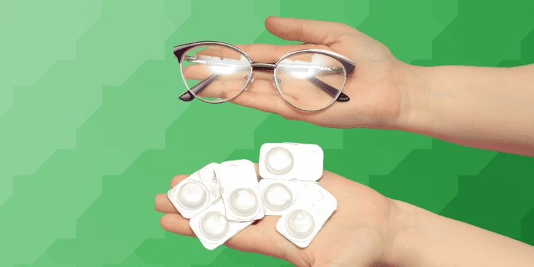Two hands holding eyeglasses and contact lens blister packs against a green geometric background.